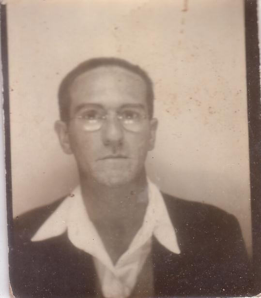 A man in a suit and glasses