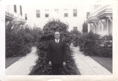 An older man in a suit posing for a photograph